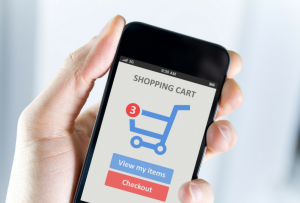 Hand holding phone showing online shopping cart