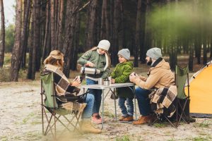 family eating outside on camping trip